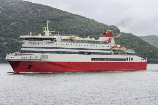 large white ship sailing in blue sea shore lengthwise