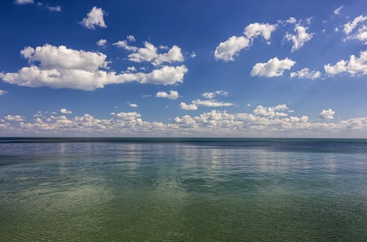 Amazing day calm sea view with clouds reflection