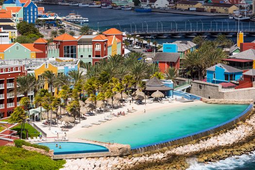 The Queen Emma Bridge is a pontoon bridge across St. Anna Bay in Curaçao. It connects the Punda and Otrobanda quarters of the capital city, Willemstad. The bridge is hinged and opens regularly to enable the passage of oceangoing vessels.