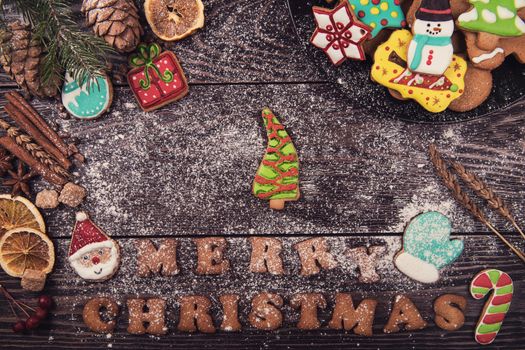 Gingerbreads for new years and christmas on wooden background with space for design