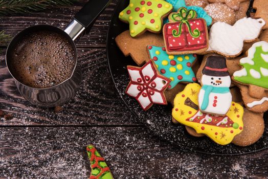 Gingerbreads and coffee for new years and christmas on wooden background, xmas theme