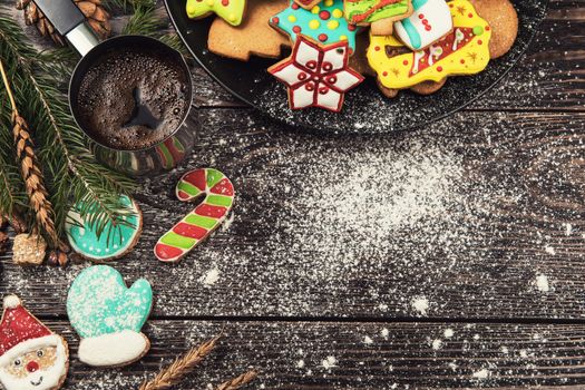 Gingerbreads and coffee for new years and christmas on wooden background, xmas theme