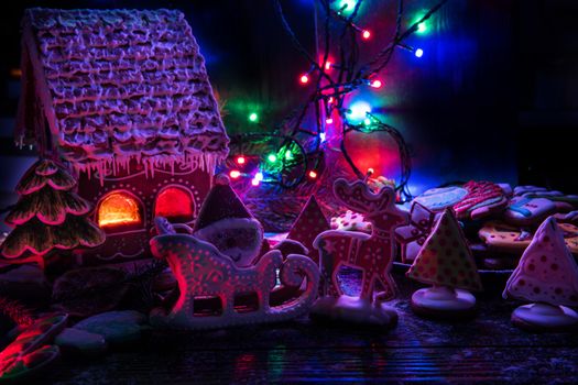 Gingerbread house with lights on dark background, xmas theme