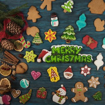 Gingerbreads for new years and christmas on wooden background with space for design