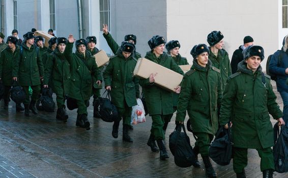 Moscow, December 2016 - The soldiers recruits in green uniforms with boxes go and look