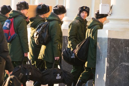 Moscow, December 2016 - The soldiers recruits in green uniforms with boxes go and look