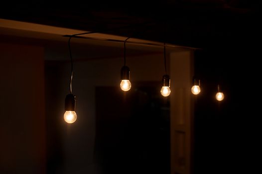 five included light bulbs in a dark room.
