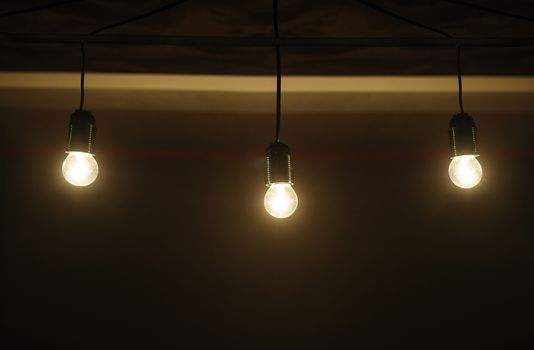 five included light bulbs in a dark room.