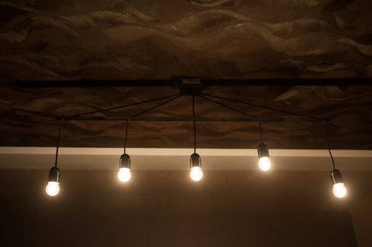 five included light bulbs in a dark room.
