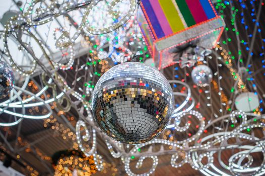 festive disco ball and Christmas Decor in park.