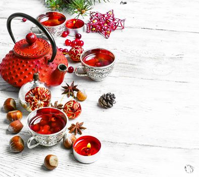 Cranberry tea in stylish cups at the Christmas background.Copy space