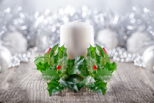 Christmas Decorations including candle on a wooden surface.