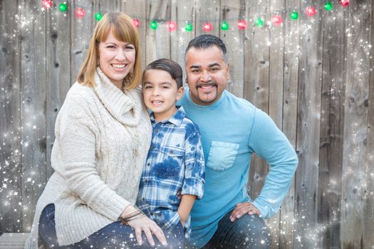 Happy Young Mixed Race Family Portrait Outside with Christmas Lights and Snow Effect.
