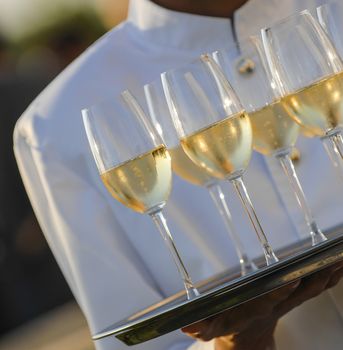 Professional male waiter in uniform serving champagne, Dri