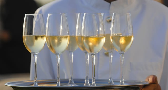 Professional male waiter in uniform serving champagne, Dri