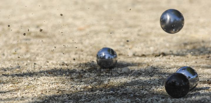 Metallic petanque three balls and a small wood jack, France