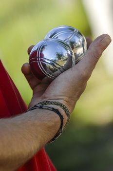 Hand of man holding petanque ball or boule, France
