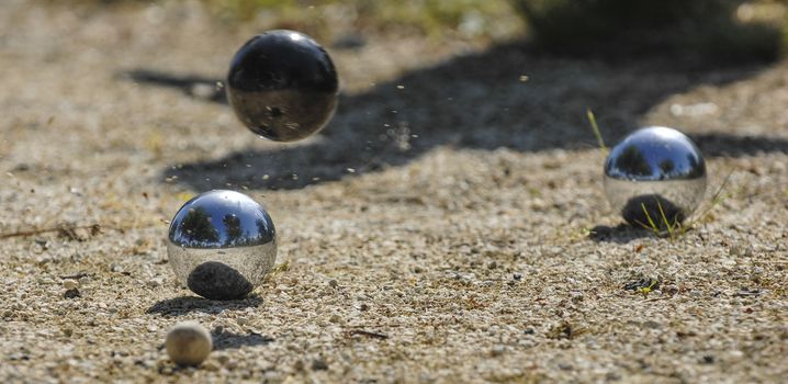 Metallic petanque three balls and a small wood jack, France