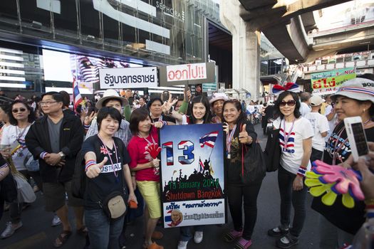 Bangkok Thailand-Jan13- thai government protester mobbing by shutdown bangkok and occupy bangkok campaign wearing  clothes and accessories nation flag color in heart of bangkok on Jan13,2014 in Bangkok Thailand
