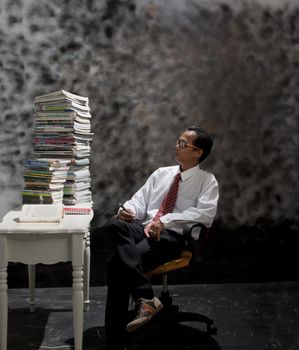 young man and big of book on table