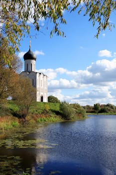 Old Russian church on Nerl river against blue sky