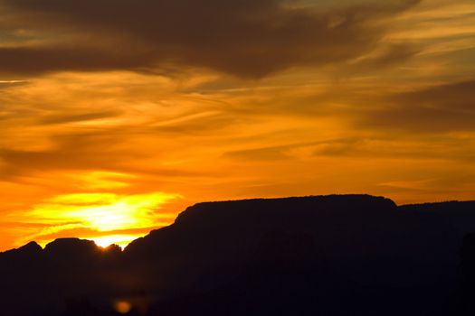 View of swirling sunset sky of light, shadow, and clouds from Navajo Point in Grand Canyon National Park in Arizona, USA.  Horizontal landscape with copy space. 