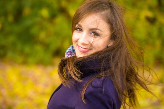 Portrait of a smiling beautiful girl with disheveled hair