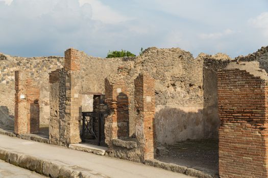 Pompeii was an ancient Roman town-city near modern Naples, in the Campania region of Italy, in the territory of the comune of Pompei. Pompeii, along with Herculaneum and many villas in the surrounding area, was mostly destroyed and buried under 4 to 6 m (13 to 20 ft) of volcanic ash and pumice in the eruption of Mount Vesuvius in 79 AD.