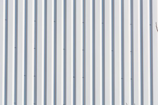 Silver-colored metal wall corrugated sheet metal background.