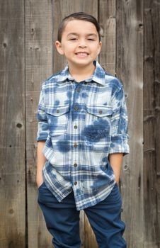 Happy Young Mixed Race Boy Portrait Against Wooden Fence.