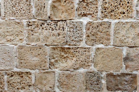 Wall built of rough weathered sandstone blocks