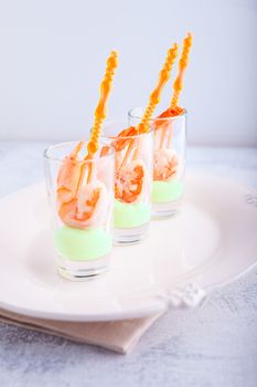 Shrimp with avocado yogurt in a glass .