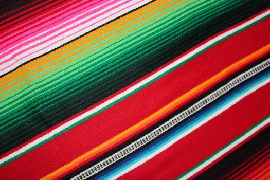 Mexico traditional cinco de mayo rug poncho fiesta background with stripes copy space