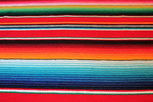 Mexico traditional cinco de mayo rug poncho fiesta background with stripes copy space