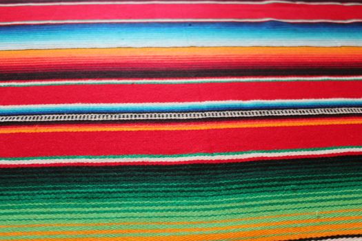 Mexico traditional cinco de mayo rug poncho fiesta background with stripes copy space