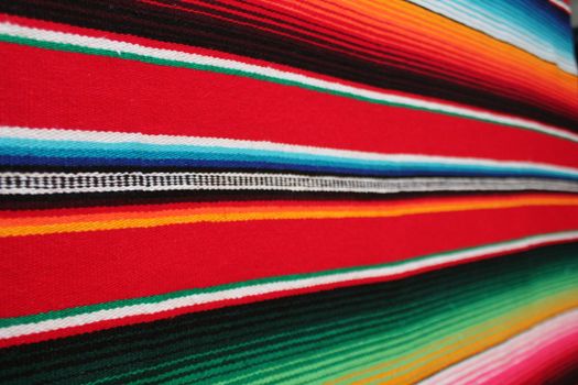 Mexico traditional cinco de mayo rug poncho fiesta background with stripes copy space