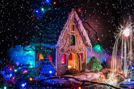 Gingerbread house with lights on dark background, xmas theme