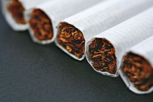 Closeup of cigarettes on black wooden table