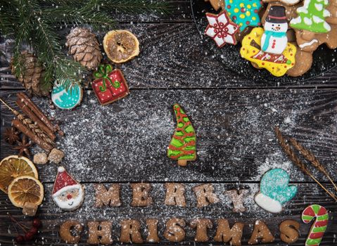 Gingerbreads for new years and christmas on wooden background with space for design