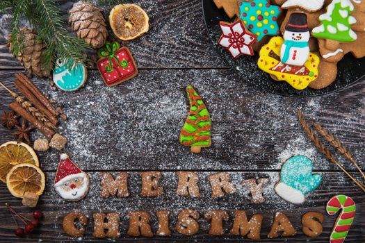 Gingerbreads for new years and christmas on wooden background with space for design