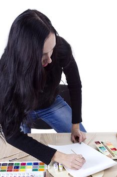 Young girl artist drawing pencils and paints