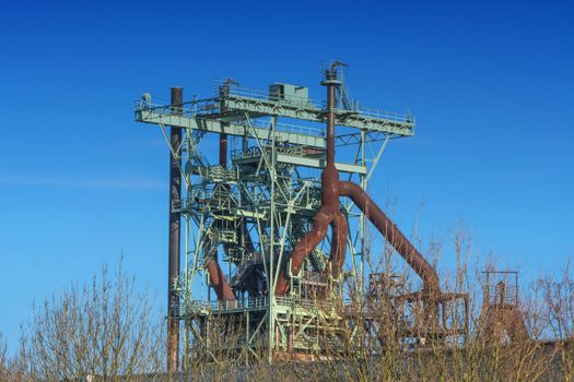 View blast furnace of an old steel mill before blue sky.