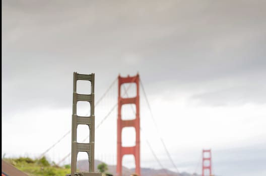 famous San Francisco Golden Gate bridge miniature with the original in the background