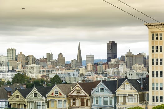 Victorian houses, known as the Painted Ladies with downtown in the background as viewed from Alamo Square in San Francisco, California