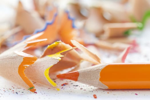 Sharpened orange pencil and wood shavings