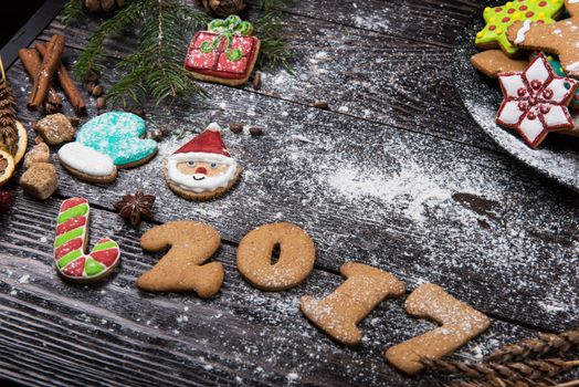 Different ginger cookies for new 2017 year holiday on wooden background, xmas theme