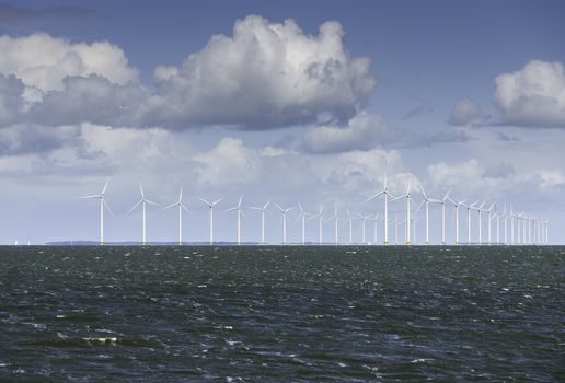 windmill park in the iijsselmeer in front of the fishers village Urk