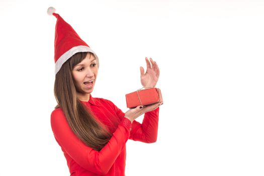 Young long-haired woman in red christmas cap and red gift box
