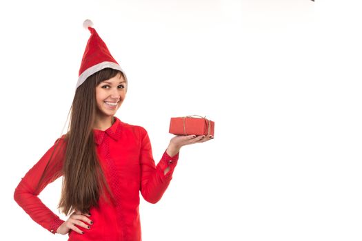 Young long-haired woman in red christmas cap holds red gift box