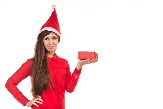 Young long-haired woman in red christmas cap holds red gift box